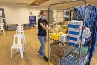 Vaccination Lead from DPV Health Kylie Rhook sets up a micro vaccination centre at Broadmeadows Community Hub.