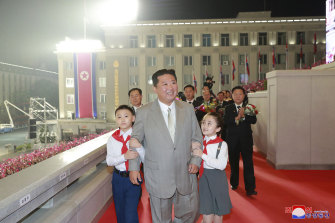 North Korean leader Kim Jong Un walks with children during a celebration of the nation’s 73rd anniversary in Pyongyang