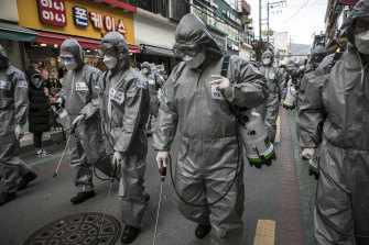 South Korean soldiers in protective gear disinfect the Eunpyeong district in a bid to stop the spread of coronavirus.
