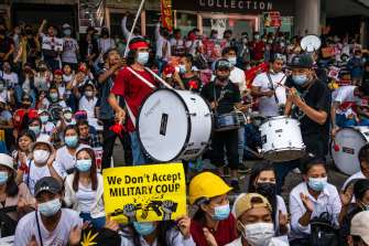 Protesters gather and make three-fingered salutes at Sule Square, downtown Yangon, on Tuesday.