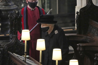 Britain’s Queen Elizabeth II takes her seat alone in St. George’s Chapel during the funeral of Prince Philip.