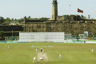Shane Warne bowls under the Dutch Fort in Galle during Australia’s Test match in 2004.