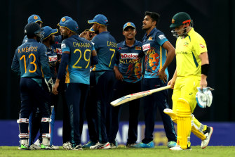Maheesh Theekshana of Sri Lanka celebrates with teammates after dismissing Aaron Finch of Australia.