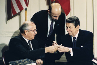US President Ronald Reagan, right, and Soviet leader Mikhail Gorbachev exchange pens during the Intermediate Range Nuclear Forces Treaty signing ceremony in the White House in 1987. 