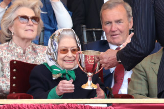 Queen Elizabeth II receives the winners cup.