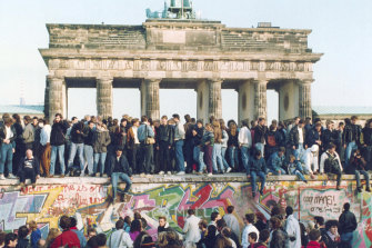 Germans from East and West celebrating on the wall the day after the borders opened on November 9, 1989. 