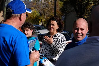 Josh Frydenberg and independent Kooyong candidate Monique Ryan hand out how-to-vote cards to people attending the Hawthorn pre-polling booth.