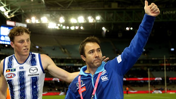 Kangaroos coach Brad Scott waves to fans after his last game as coach for North.