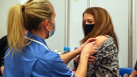 A woman receives the Moderna COVID-19 vaccine in Reading, England.