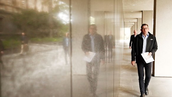 Victorian Premier Daniel Andrews walks in for his daily COVID-19 media conference on Sunday.