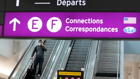 People travel at Pearson International Airport during the COVID-19 pandemic in Toronto. New travel testing and restrictions have been put in place due to the Omicron variant.  
