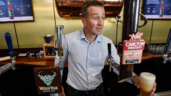 Carlton & United Breweries chief executive Peter Filipovic behind the bar at the company's Abbotsford headquarters.