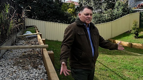 Scott Hinks in his Windsor backyard, which was under approximately four metres of flood water. 