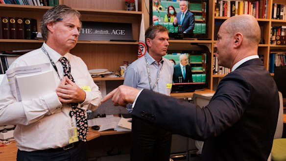 Treasurer Josh Frydenberg visits the offices of The Sydney Morning Herald and The Age during the 2022 budget lock-up. Also pictured are Shane Wright and David Crowe.
