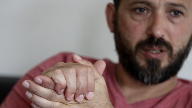 Al Noor mosque shooting survivor Temel Atacocugu gestures during an interview at his home in Christchurch, New Zealand.