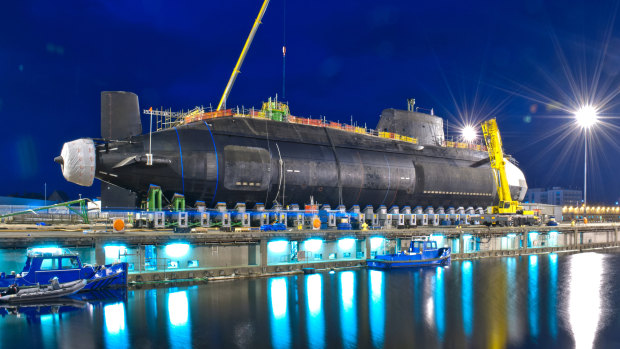 Britain’s third Astute Class nuclear submarine, the Artful, being lowered into the water. 
