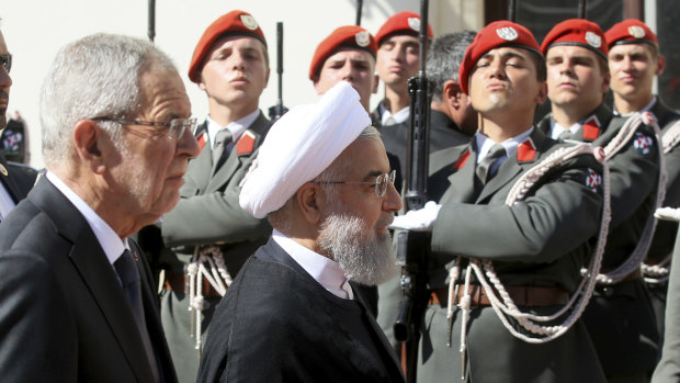 Austrian President Alexander Van Der Bellen, left, and Iranian President Hassan Rouhani attend a military welcome ceremony as part of a meeting in Vienna.