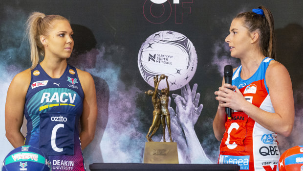 Kate Moloney of Melbourne Vixens looks on as Maddy Proud of NSW Swifts speaks at this week's season launch.