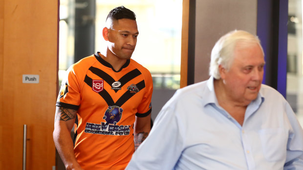 Israel Folau and Clive Palmer enter their press conference.