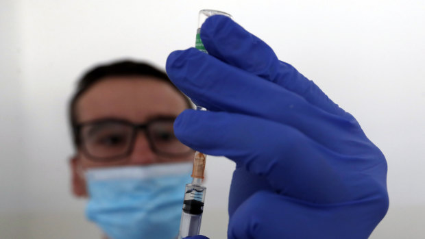 A medical worker prepares to administer a dose of the AstraZeneca vaccine.