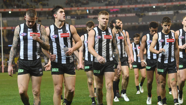 Feeling the strain: Ben Crocker, Brayden Maynard and Jordan de Goey (L-R) lead the Magpies off the field after Friday night's loss to the Tigers.