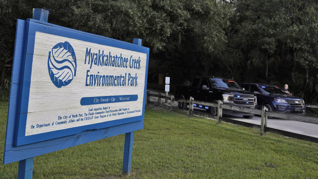 Police officer block the entrance to the Myakkahatchee Creek Environmental Park in North Port, Florida. 