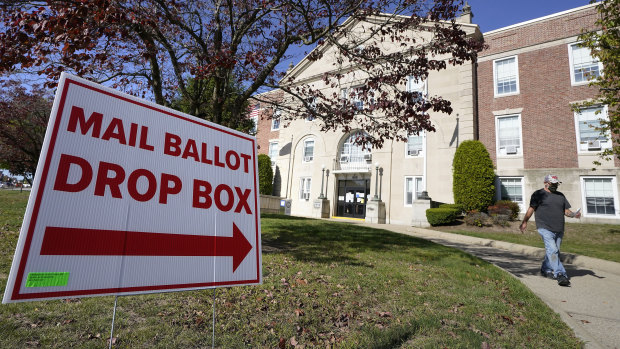 A signs points the way to a ballot drop box in front of Cranston City Hall, in Cranston, Rhode Island.