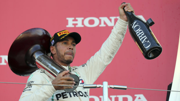 Home straight: Lewis Hamilton, celebrating in Japan earlier this month, is on the brink of another world title.