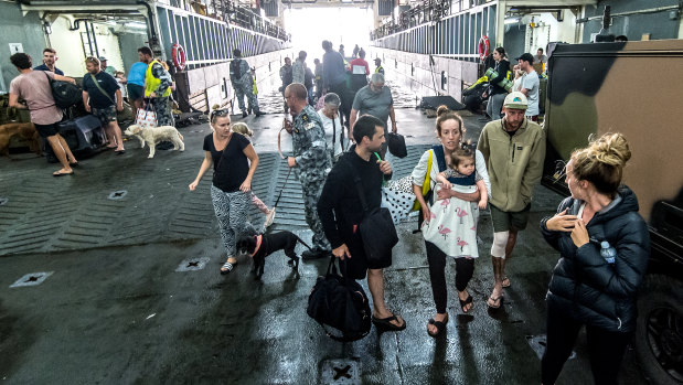 The first group of evacuees from Mallacoota have been welcomed aboard the HMAS Choules. 