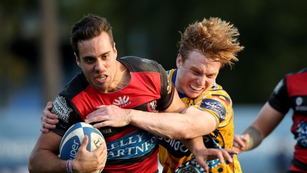 Norths winger Nathan Russell is tackled in their heavy defeat to Sydney Uni.
