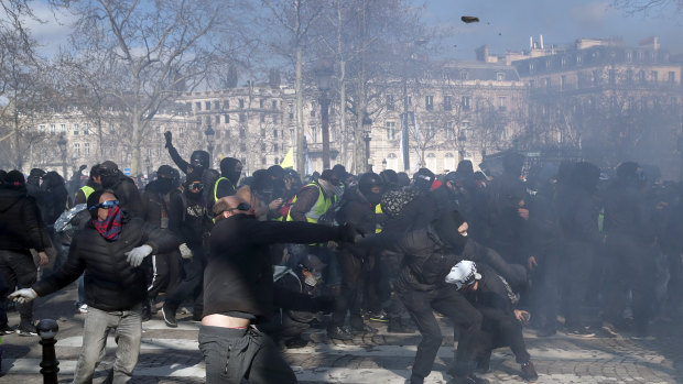 Protesters clash with riot police during a yellow vests demonstration in Paris. 