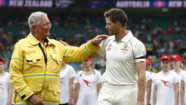 Australia captain Tim Paine greets John Corry of the Ku-ring-gai Fire Brigade on Friday.