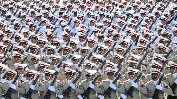 Iranian armed forces members march in a military parade marking the 36th anniversary of Iraq's 1980 invasion of Iran, just outside Tehran, Iran.