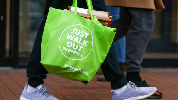 Just walk out: a customer carries a reusable bag after shopping at a cashierless store.
