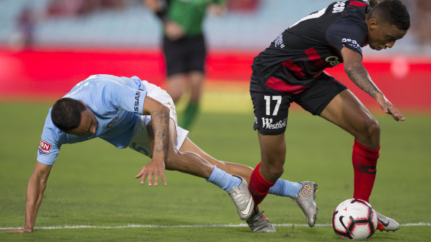 Sibling rivalry: Kearyn Baccus of Melbourne City tackles borther Keanu Baccus during the New Year's Day clash.