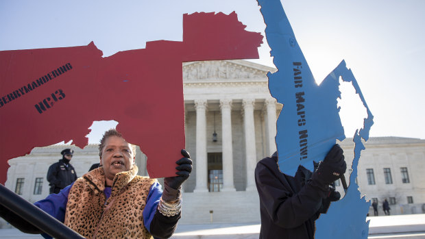 Activists gathered outside the US Supreme Court in March as it heard separate cases on gerrymandering and the census.