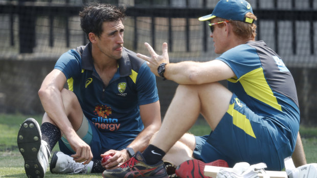 Andrew McDonald chats with Mitchell Starc during training for the Boxing Day Test in 2019.