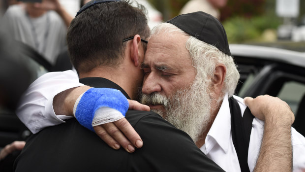 Rabbi Yisroel Goldstein (right) lost a finger during the shooting.
