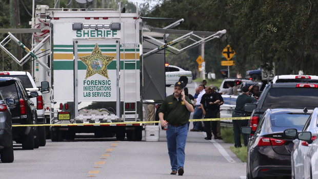 Polk County Sheriff’s officials work the scene of a multiple fatality shooting.
