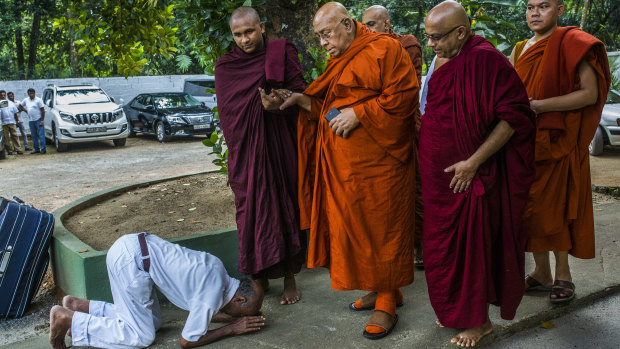 A Sri Lankan Buddhist bows in front of Sitagu Sayadaw, one of Myanmar’s most revered Buddhist leaders, in Delgoda, Sri Lanka.