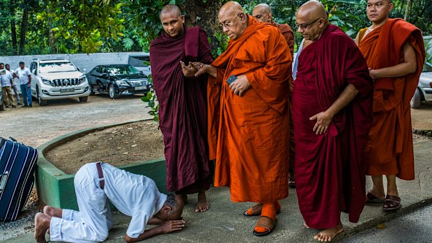 A Sri Lankan Buddhist bows in front of Sitagu Sayadaw, one of Myanmar’s most revered Buddhist leaders, in Delgoda, Sri Lanka.