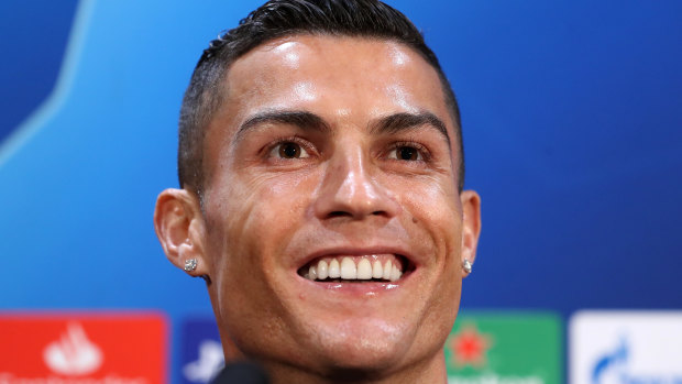 Smiling assassin: Cristiano Ronaldo is refusing to let a rape allegation get him down.