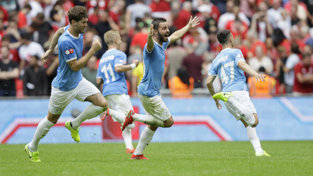 First blood: Manchester City's celebrate winning the penalty shootout.