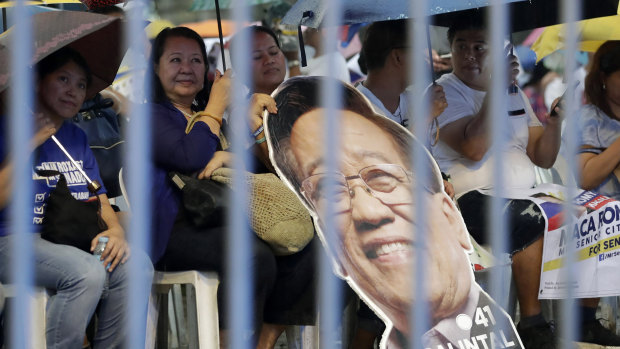 Supporters of opposition senatorial candidates rally in suburban Quezon city, northeast of Manila, Philippines. 