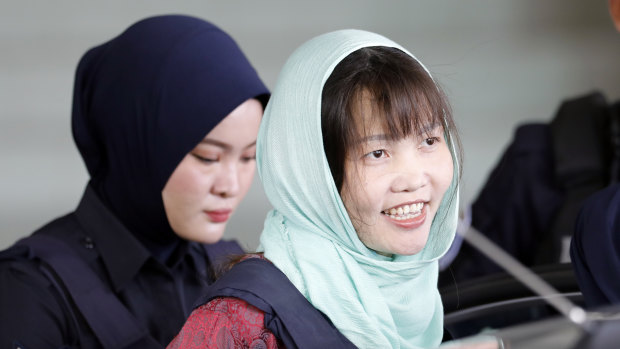 Doan Thi Huong, right, leaves Shah Alam High Court in Malaysia on Monday after pleading guilty to causing harm.