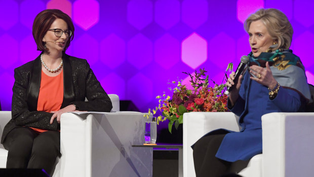 Former US secretary of state Hillary Clinton speaks with former Australian prime minister Julia Gillard.