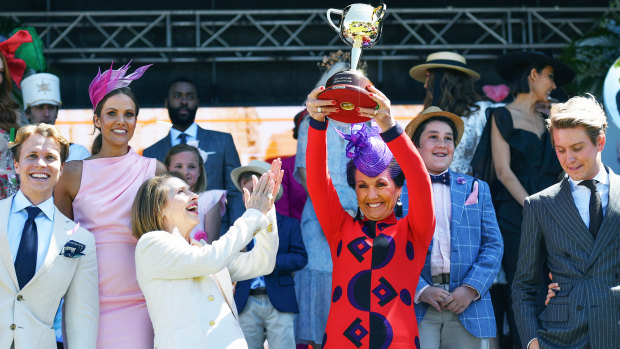 Victoria Racing Club chairman Amanda Elliott (centre), holds the Melbourne Cup aloft at Monday's launch alongside racing identities including Gai Waterhouse (third from left).