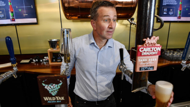 Carlton & United Breweries chief executive Peter Filipovic behind the bar at the company's Abbotsford headquarters.