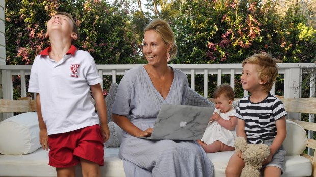 Lija Wilson working at home with children Jack (left), Harry (right) and baby Evie.