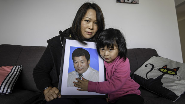Elsa Voong and her daughter hold a picture of her husband Sam.